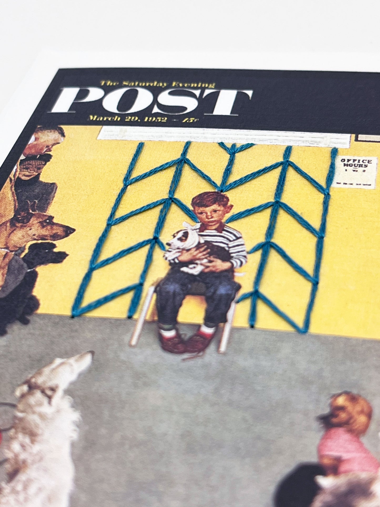 greeting card with a print of an issue of The Saturday Evening Post, a picture of a a boy holding his dog at the vet looking worried, with hand embroidered chevron pattern on the wall behind him