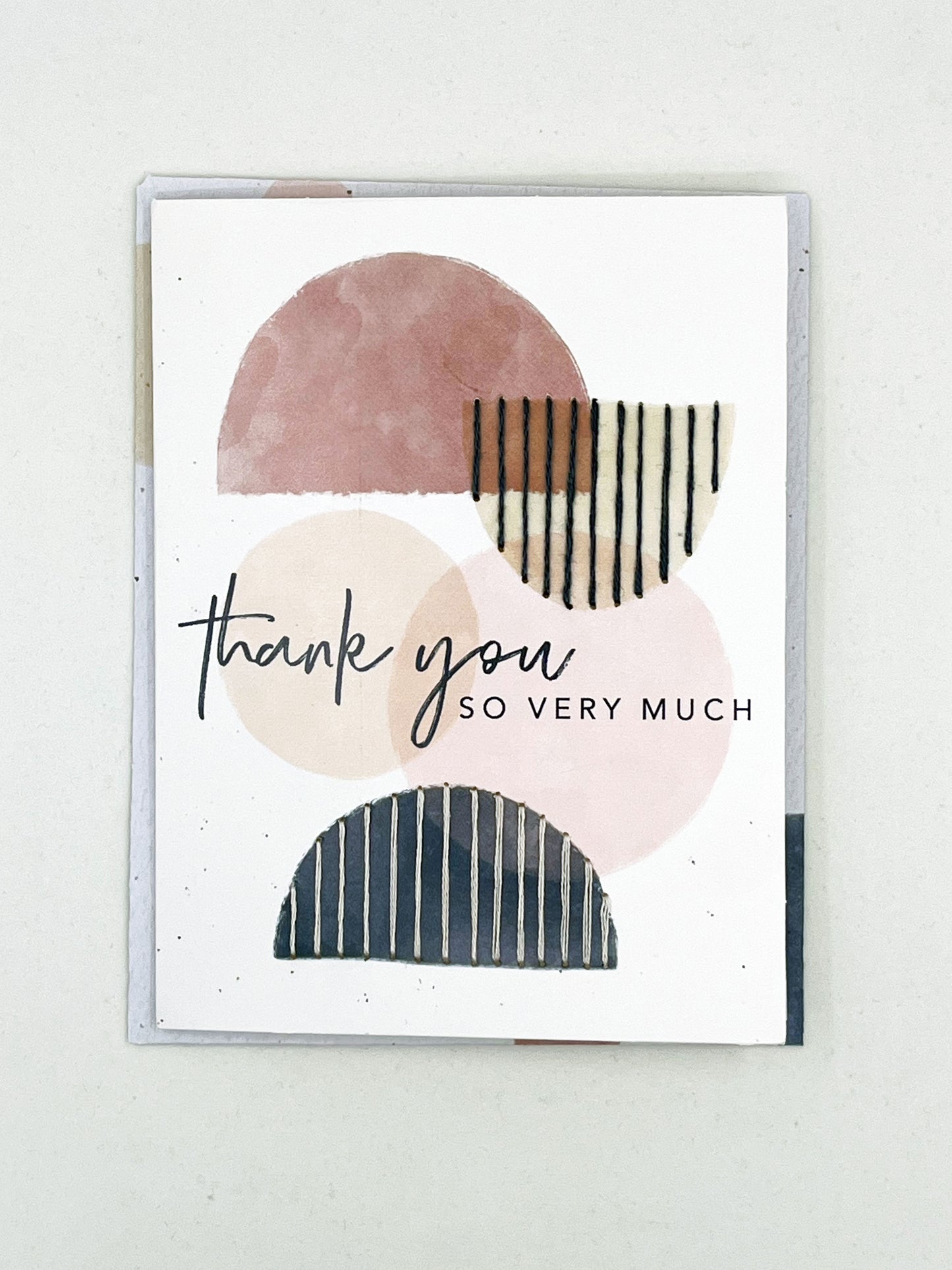 greeting card that says thank you so very much on it, with circles and half circles in mauve peach and navy, some of the half circles are stitched over with vertical lines in contrasting colors