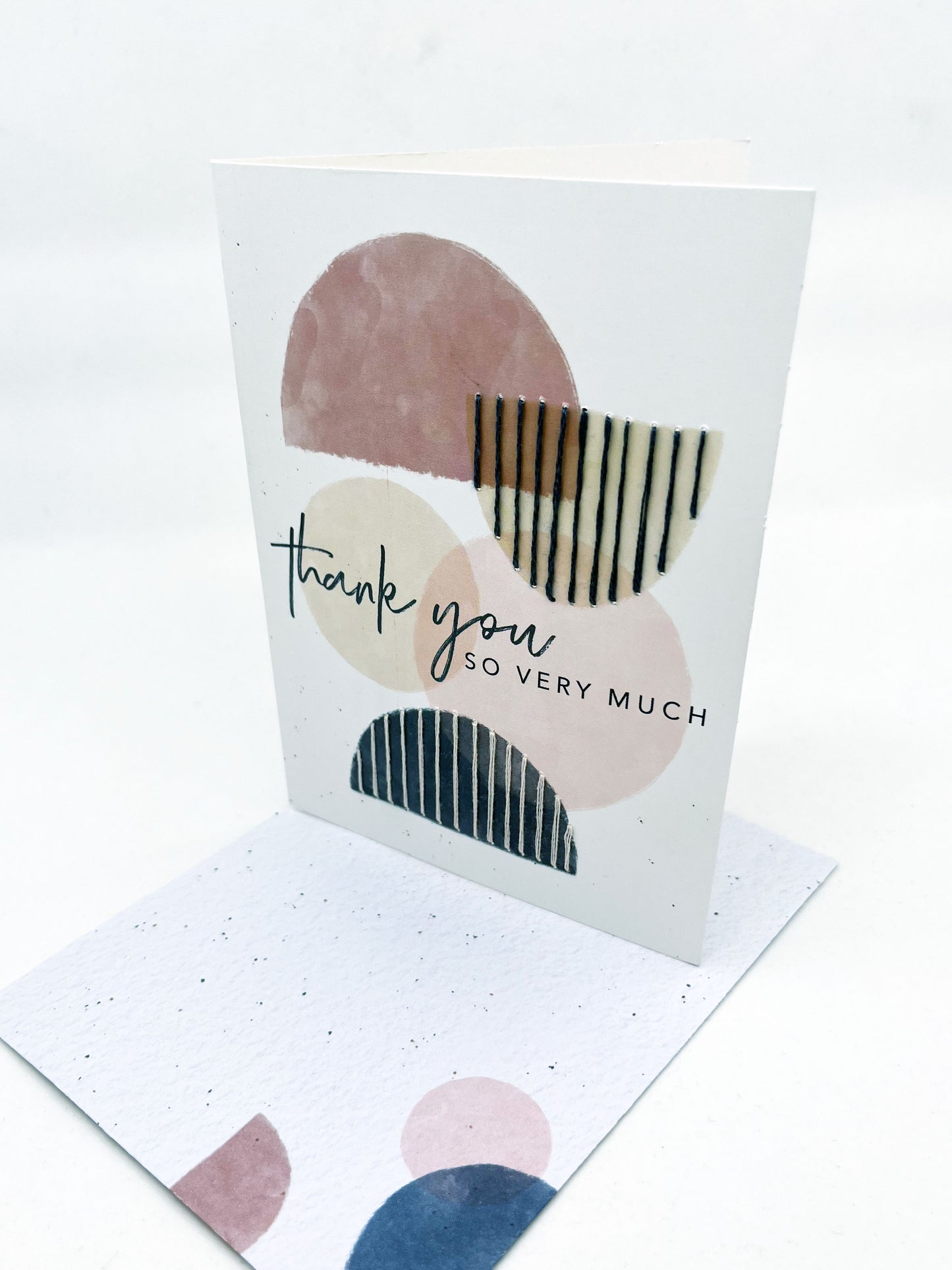 greeting card that says thank you so very much on it, with circles and half circles in mauve peach and navy, some of the half circles are stitched over with vertical lines in contrasting colors