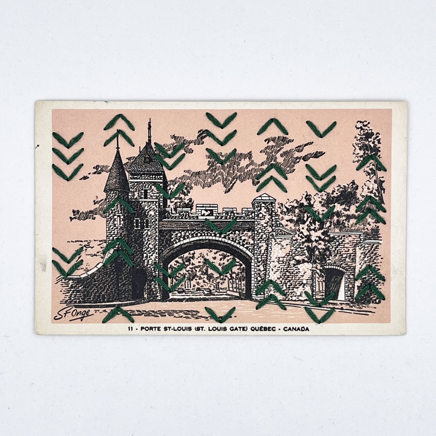 a peach colored vintage postcard of a drawing of St Louis Gate in Quebec, with a pattern of rows of irregularly placed small chevrons hand stitched over it in pine green floss