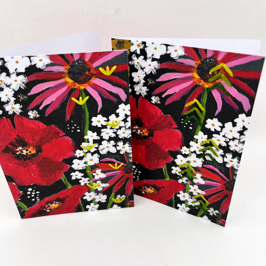 Two greeting cards standing upright. artwork of painted flowers in red pink and white. Green stitches of groups of 3 chevrons to create abstract pine tree shape on one card, chartreuse stitches in shapes on sprouts on the other card
