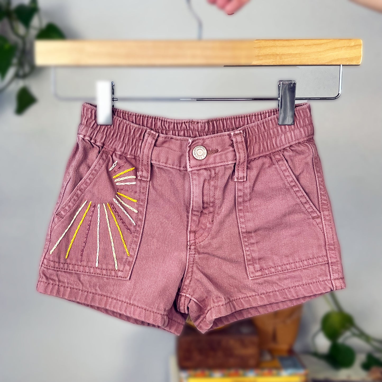 mauve kids shorts with sunbeams hand embroidered in chainstitch on the front pocket