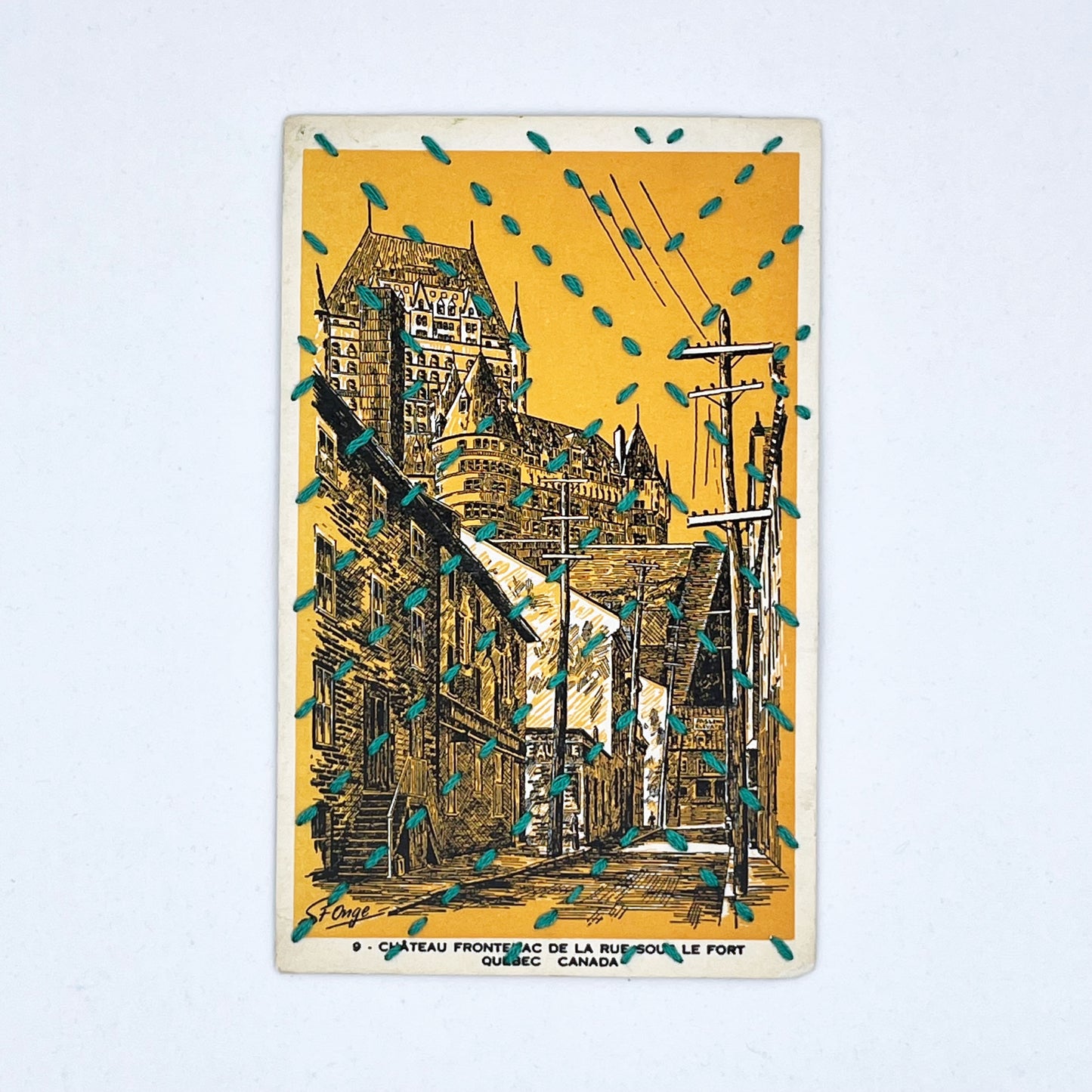a golden yellow vintage postcard depicting a drawing of the Chateau Frontenac in Quebec, stitched over with running stitches in teal floss in a radiating X pattern