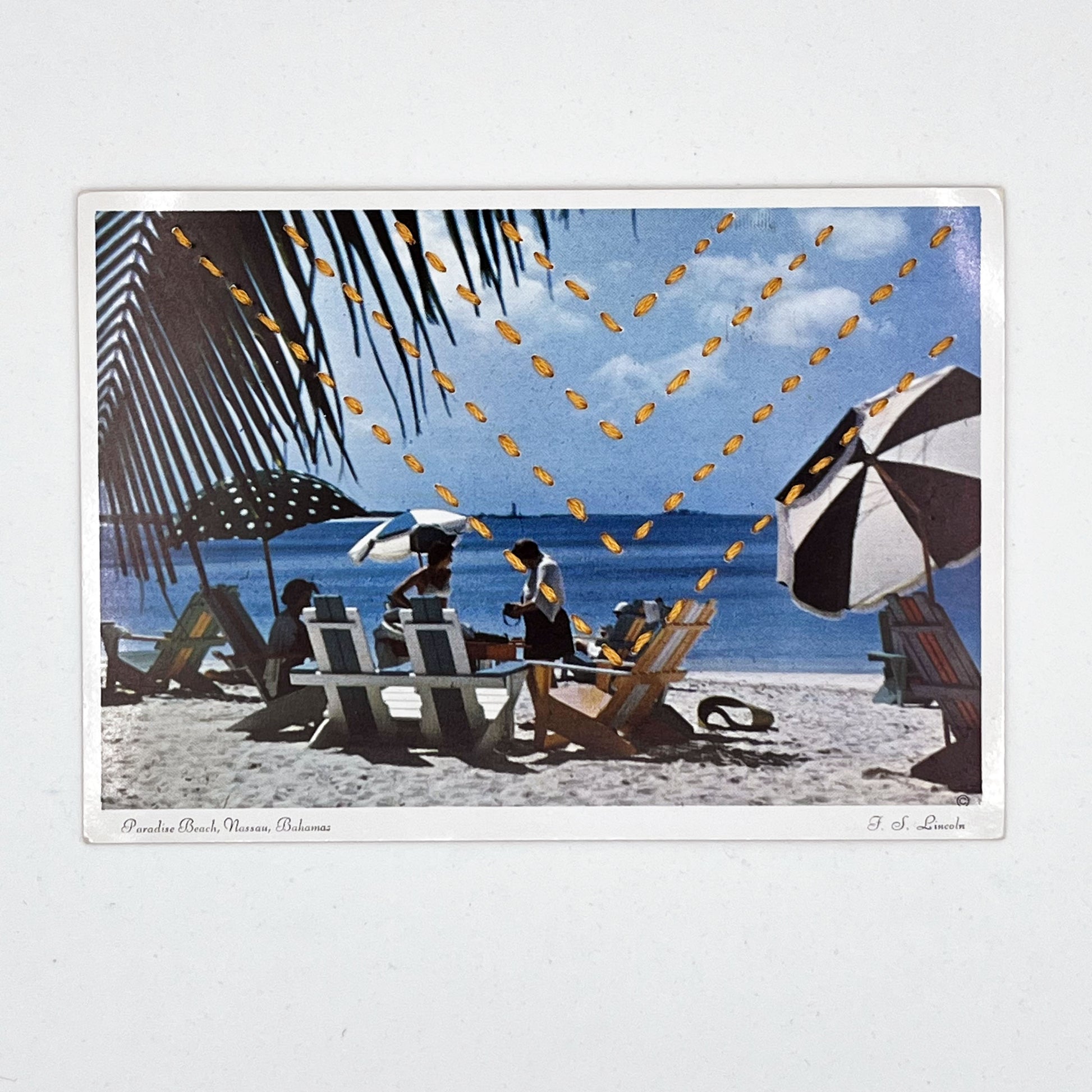 vintage postcard of a beach in the Bahamas with beach umbrellas and a palm tree, hand stitched with four rows of chevrons in yellow